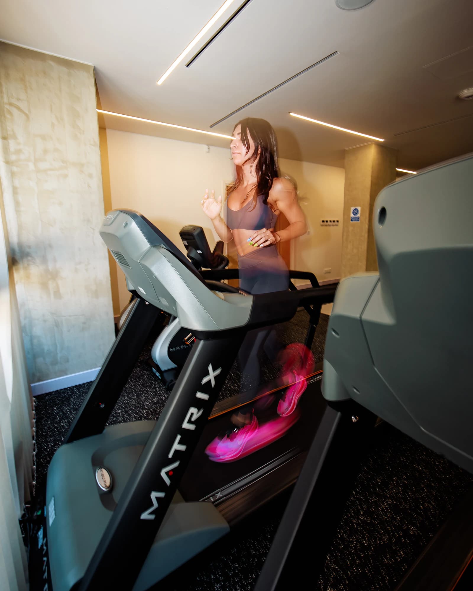 A client completing supervised treadmill work in AION rehabilitation